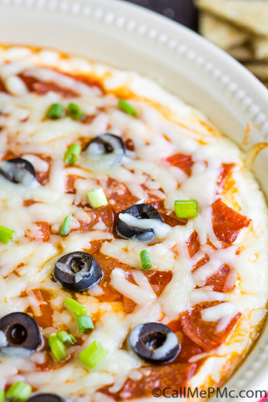 To Die For Pizza Dip is a cheesy, gooey dip that tastes like everyone's favorite comfort food. A layer of cream cheese is topped with tomato sauce and your favorite pizza toppings.