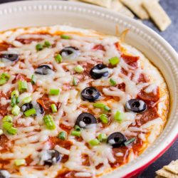 A delicious creamy cheesy pizza dip loaded with sauce & your favorite toppings, hot from the oven!