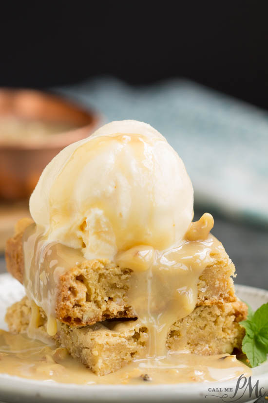 White Chocolate Walnut Blondies a rich & decadent copycat recipe from Applebee's restaurant chain. It's full of chocolate chunks, walnuts and coconut. #blondies #walnuts #brownies #recipe #dessert #chocolate #whitechocolate #easy Two blondie squares stacked on top of each other with a scoop of ice cream and sauce poured over all.