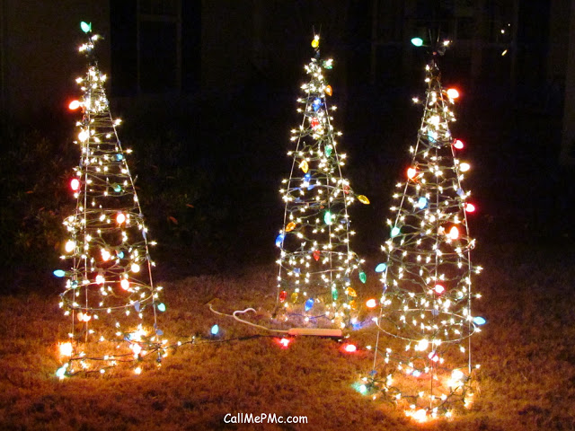 Lighted Christmas trees built using tomato cages.