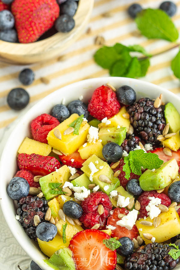 bowl of fruit with blueberries and strawberries Avocado Fruit Salad with Cranberry Vinaigrette