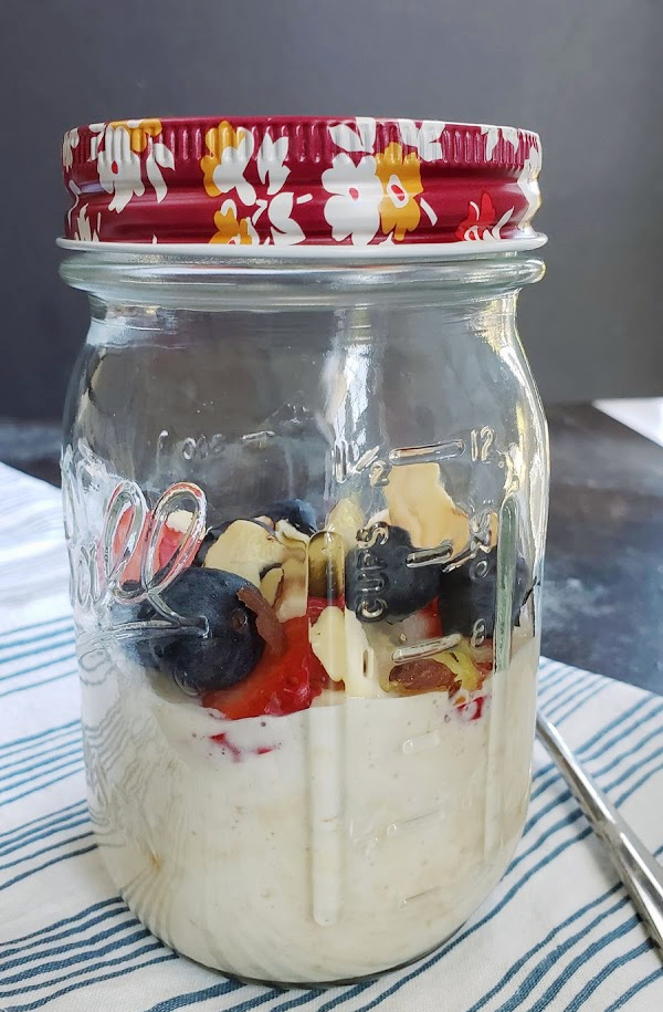 Mason jar with overnight oats and fruit Overnight oatmeal in a Ball canning jar.