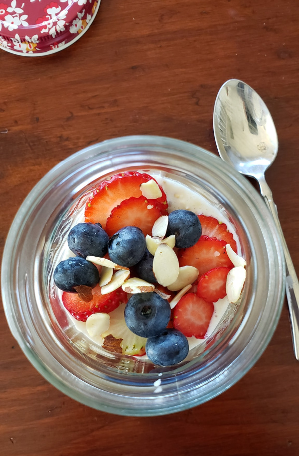 quick overnight oatmeal in a dish with fresh berries and almonds.