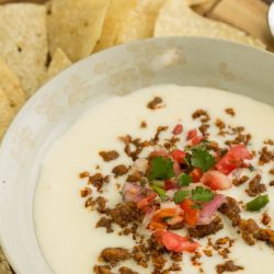 Taco meets cheese for a melty, cheesy, comfort situation in my Spicy Chorizo Queso! A fantastic, shareable, warm, cheesy dip that’s easy to make and perfect for every party.