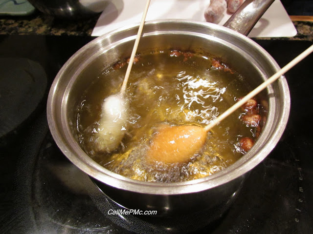 mini sausage corn dogs in fryer, one cooked mini sausage corn dogs in deep fryer, one cooked