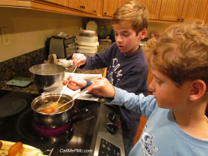 2 kids frying mini corn dogs