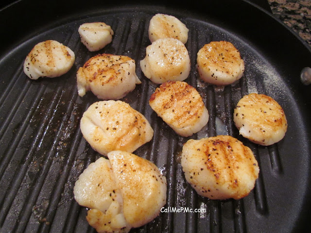 large scallops seared in a pan large scallops seared in a pan