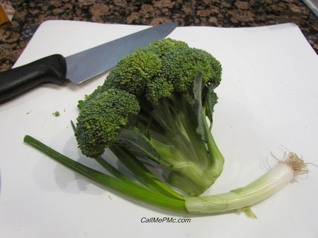 broccoli and green onion on a cutting board.