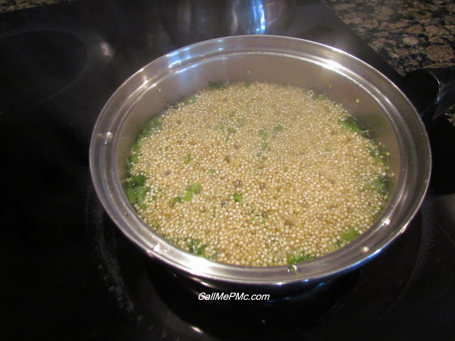 quinoa and broccoli cooking in a pot.