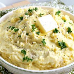 Roasted Garlic Mashed Potatoes are creamy and rich. They're delicious enough to serve as a holiday side dish but easy enough to make on a busy weeknight. #garlic #potatoes #comfortfood #mashedpotatoes #sidedish #Thanksgiving #holidays