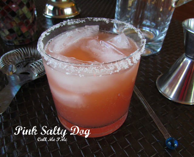 Grapefruit salty dog Cocktail with ice in glass on gray stone background Grapefruit salty dog Cocktail with ice in glass on gray stone background