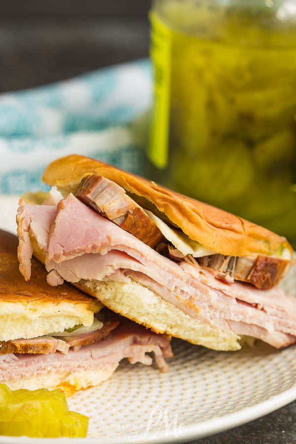 grilled sandwich on bun with meat, cheese, and pickles grilled sandwich on bun with meat, cheese, and pickles