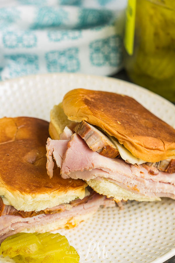 grilled sandwich on bun with meat, cheese, and pickles grilled sandwich on bun with meat, cheese, and pickles