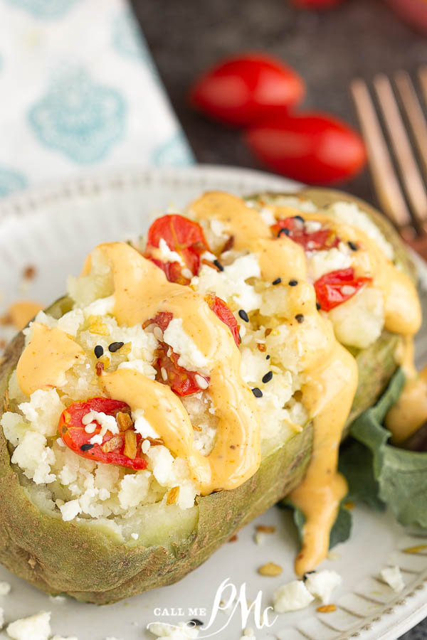 Spicy sauce covered stuffed potato Twice Baked Feta Tomato Potatoes