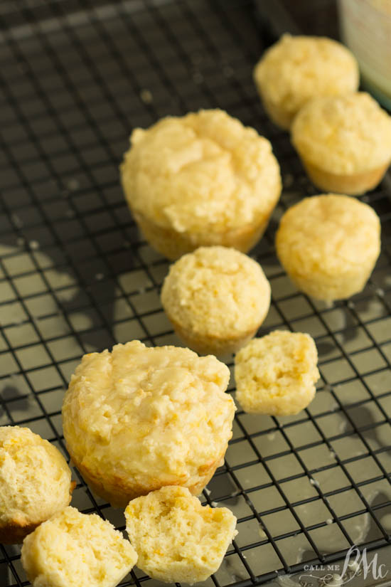 Breakfast recipe. Brighten your day with these little bits of sunshine! Orange Muffins are topped with a sweet citrus glaze and make a tasty on-the-go breakfast. Orange mini muffins cooling on a wire rack.