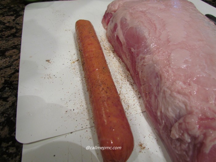 Loin and sausage on a cutting board.