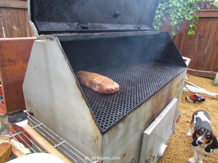 A smoker with meat on it.