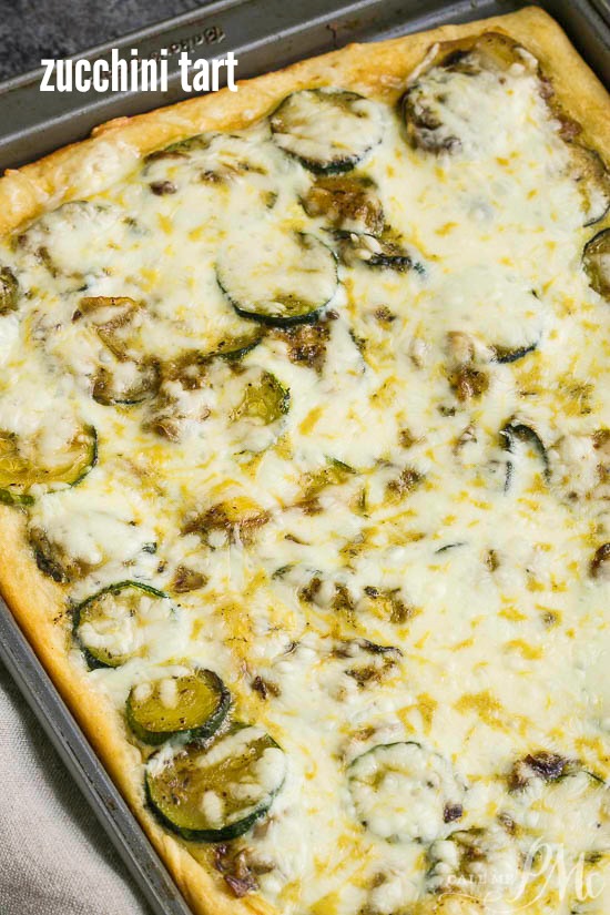 Fresh Zucchini Tart starts with an easy premade crust, topped with zucchini then smothered with cheese. #zucchini #baked Vegetable pizza baked to perfection and cut into rectangular pieces, is topped with melted cheese and garnished with aromatic basil leaves.