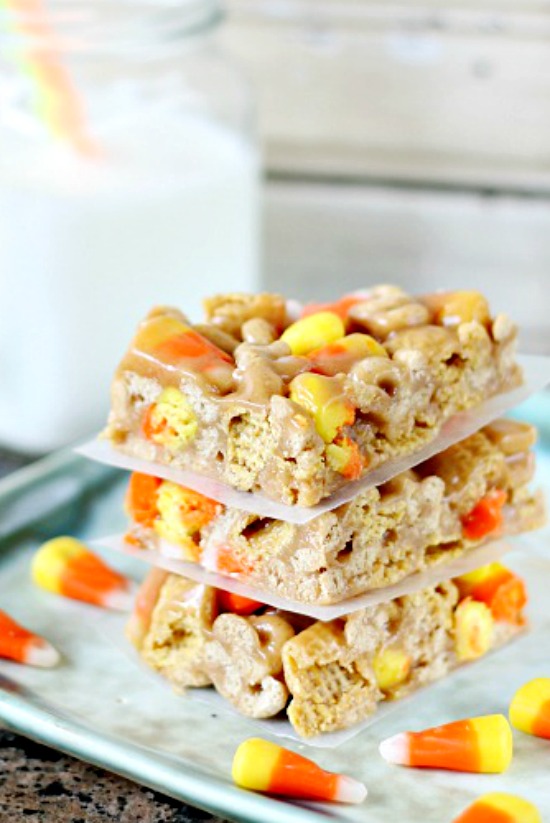 stack of cereal bars on a plate surrounded by candy corn.