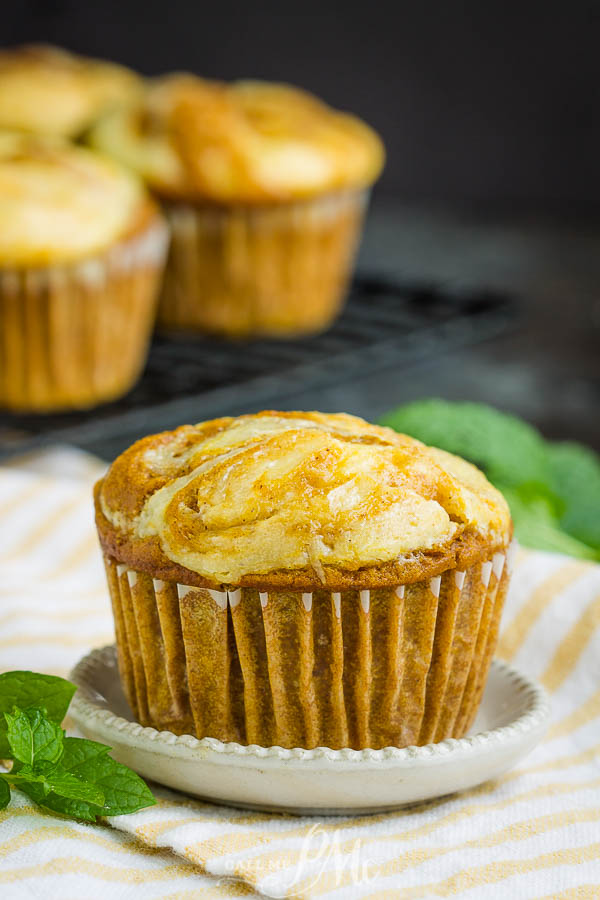 Perfectly soft and moist, Pumpkin Cream Cheese Swirl Muffins are topped with a luscious swirl of cheesecake. #muffins #pumpkin #easy #breakfast #recipe #cheesecake #brunch #pumpkinpie Pumpkin Cream Cheese Swirl Muffins