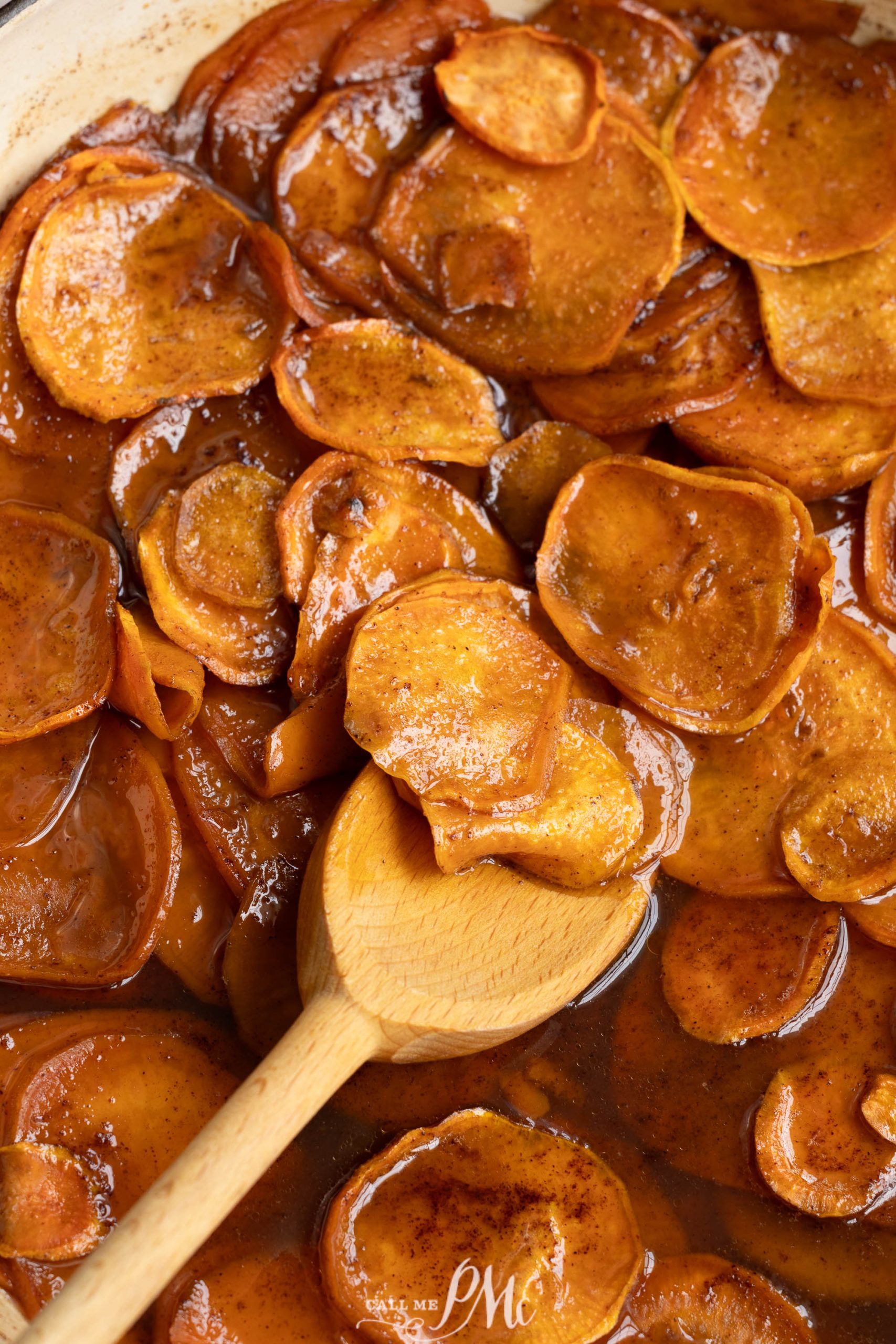 Close-up of slices of root vegetables coated in a glossy, spiced syrup.