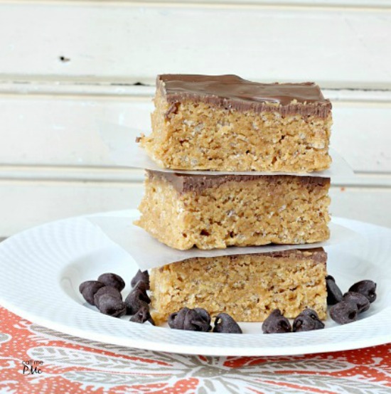 Stack of three crispy peanut butter cereal bars topped with chocolate.