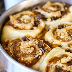 Snickers Bars Cinnamon Rolls, pillowy soft dough is full of buttery caramel, rich chocolate, and crunchy peanuts. These gourmet sweet rolls are pure decadence!