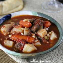 A bowl of old-fashioned beef stew features tender chunks of beef, carrots, and potatoes immersed in a rich broth, reminiscent of a classic vegetable soup recipe.