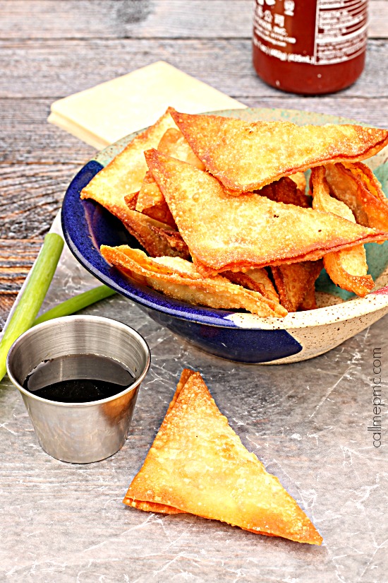 Wontons stuffed with bacon and cream cheese stuffed wontons in a bowl.