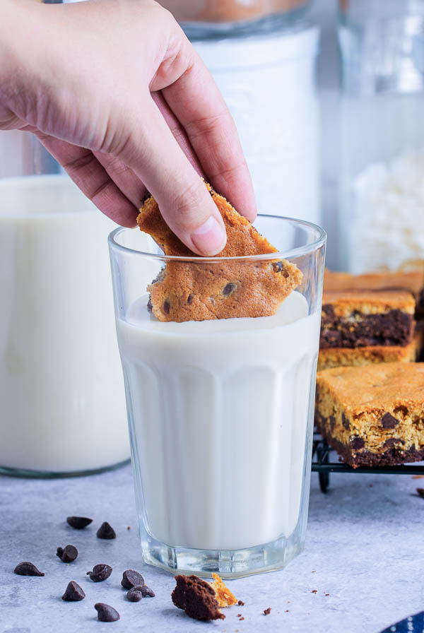 Dipping cookie bar in milk