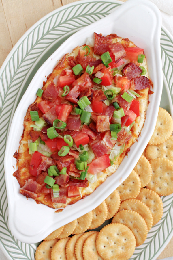 BLT Dip is quick, easy, tasty, & the perfect appetizer. This creamy dip, served hot or cold, is filled with bacon, tomatoes, & green onions.