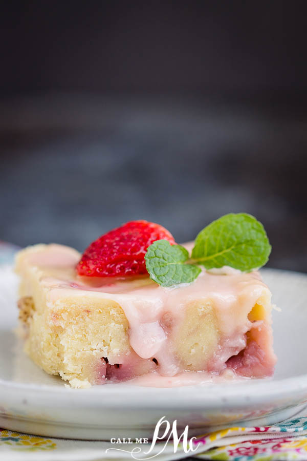 Cake with icing and a strawberry on top Fresh Strawberry Yogurt Cake