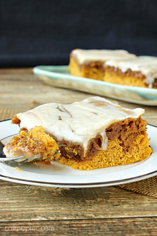 Tender and moist, Pumpkin Cinnamon Roll Cake is simply divine! It's incredibly simple to prepare and requires no waiting for yeast to activate and dough to rise. You'll be enjoying this dessert in less than an hour! #pumpkin #cake #cakemix #cinnamon #cinnamonroll Dessert on a plate with a bite on a fork.