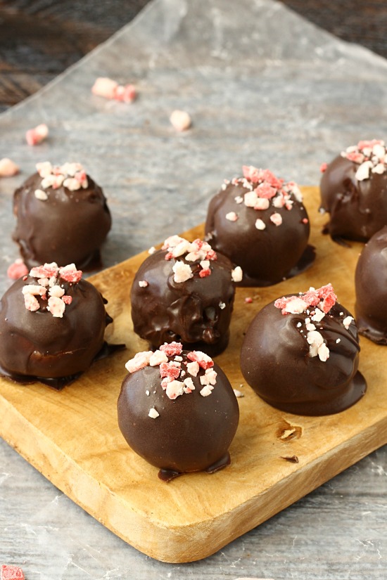 Incredibly simple Peppermint Truffles Recipe starts with a cream cheese base full of peppermint chips, rolled into balls then they're draped in chocolate... I want to be draped in chocolate! Peppermint Truffles