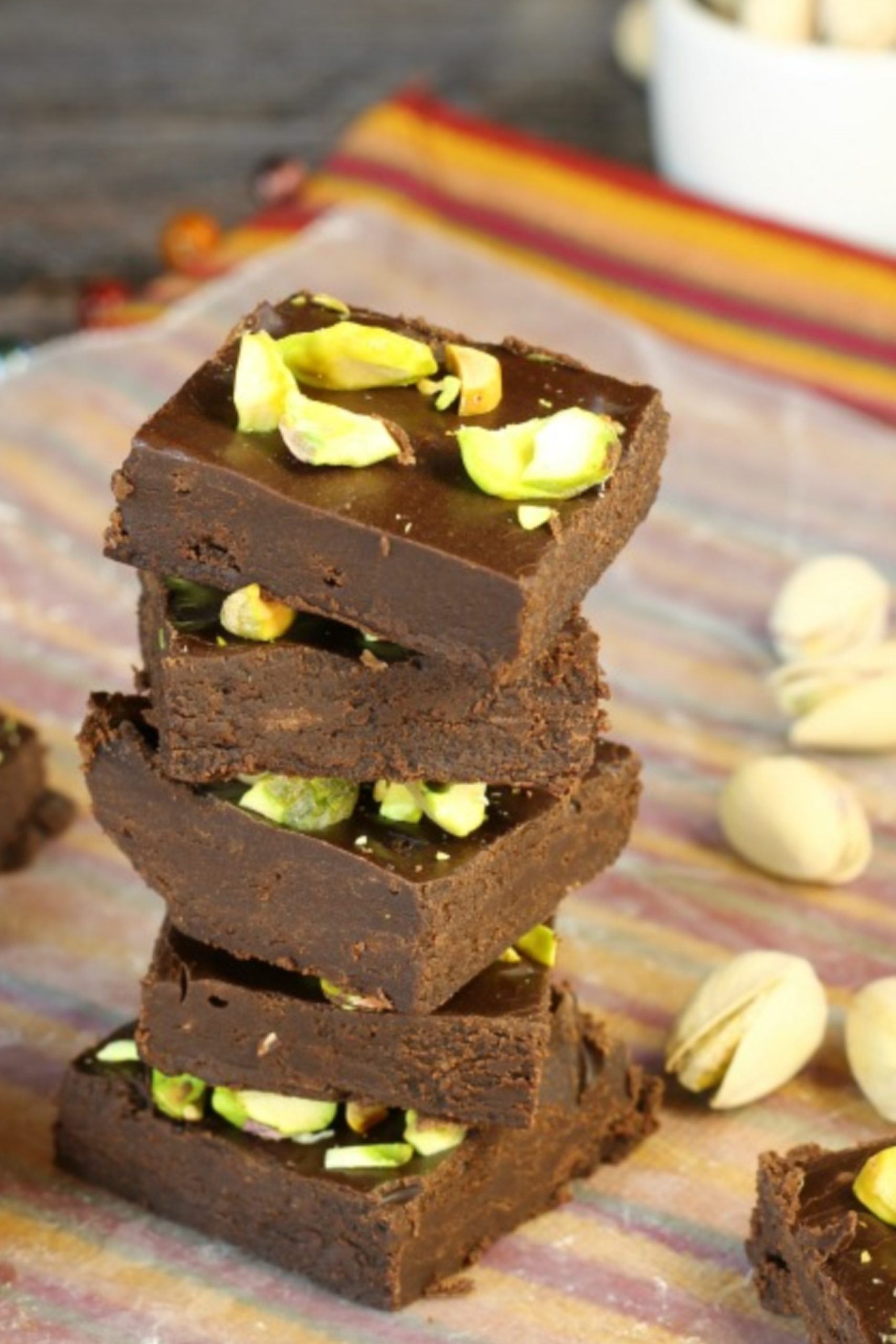 A stack of 5 Minute Dark Chocolate Fudge with pistachios and nuts.