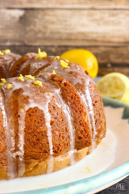 Glazed lemon bundt cake on a white platter.