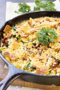 skillet of macaroni and cheese with bacon and baby kale.