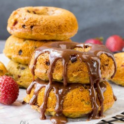 stack of chocolate chip donuts with chocolate glaze.