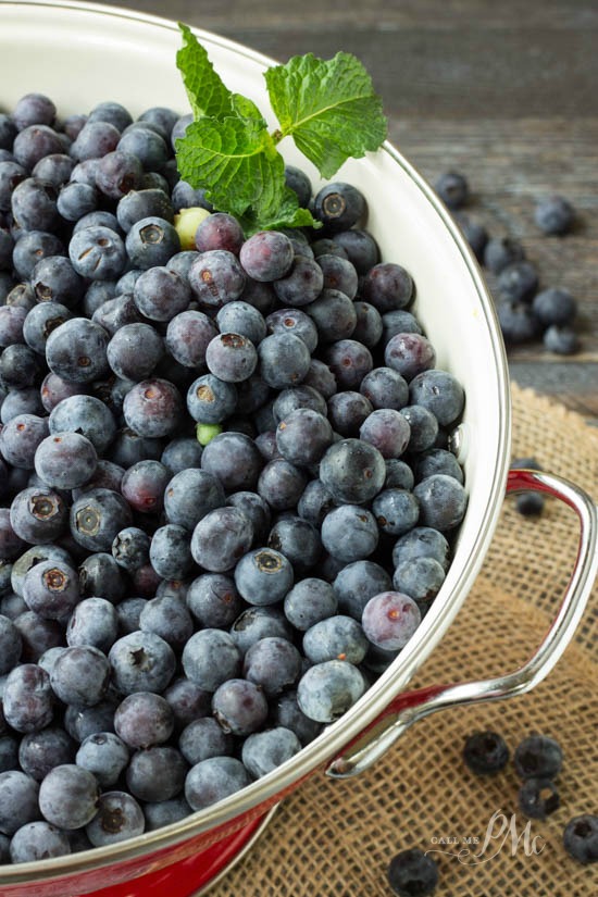 colander full of fresh blue berries.