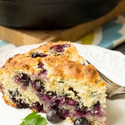 blueberry buttermilk cornbread slice on a plate.