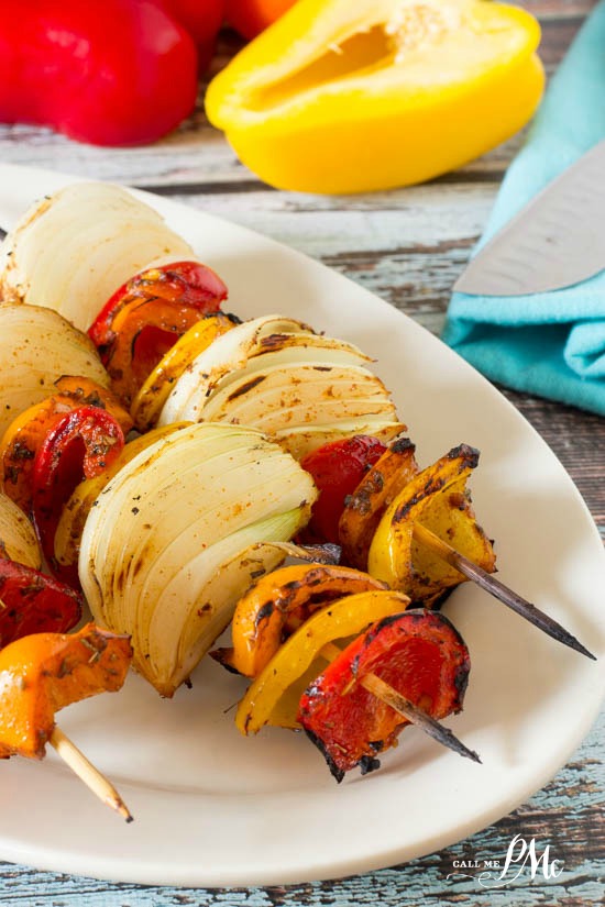 chicken fajita skewers on a white plate.