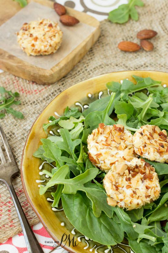 Almond Crusted Goat Cheese on a plate of fresh greens.
