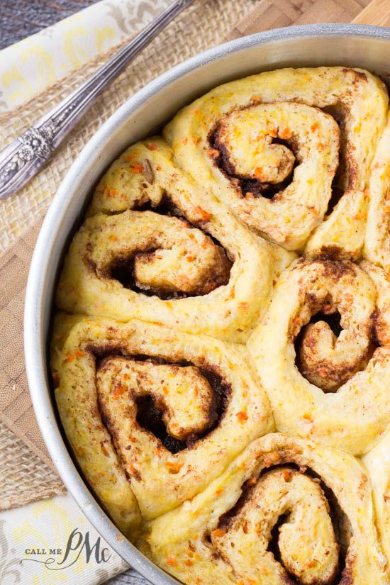 Scratch Made Carrot Cake Cinnamon Rolls with Cream Cheese Frosting recipe warm sweet rolls filled with cinnamon and butter and topped with cream cheese frosting oozing down into the warm cinnamon rolls! Great breakfast and brunch recipe. Scratch Made Carrot Cake Cinnamon Rolls