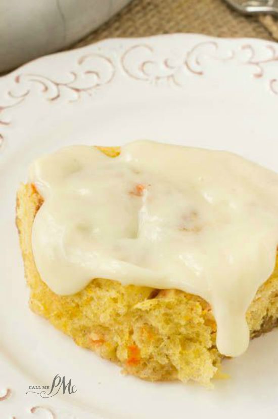 Scratch Made Carrot Cake Cinnamon Rolls with Cream Cheese Frosting recipe warm sweet rolls filled with cinnamon and butter and topped with cream cheese frosting oozing down into the warm cinnamon rolls! Sweet rolls with icing dripping off top.