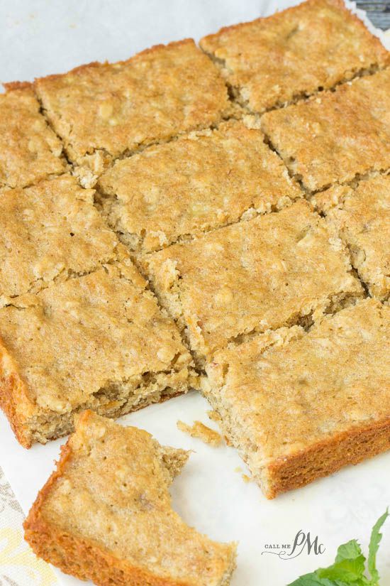 A tray of freshly baked sliced Peanut Butter Oatmeal Breakfast Blondies on a white surface.