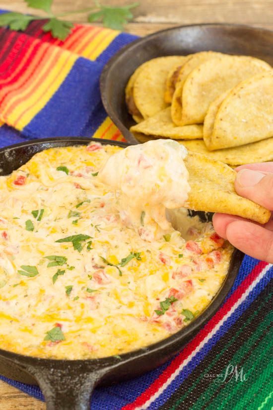 A person indulging in a Tex-Mex cheese dip with tortilla.