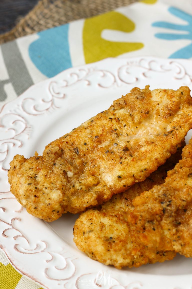 Two breaded and fried Copycat Chick-fil-a Chicken Strips served on a white decorative plate.