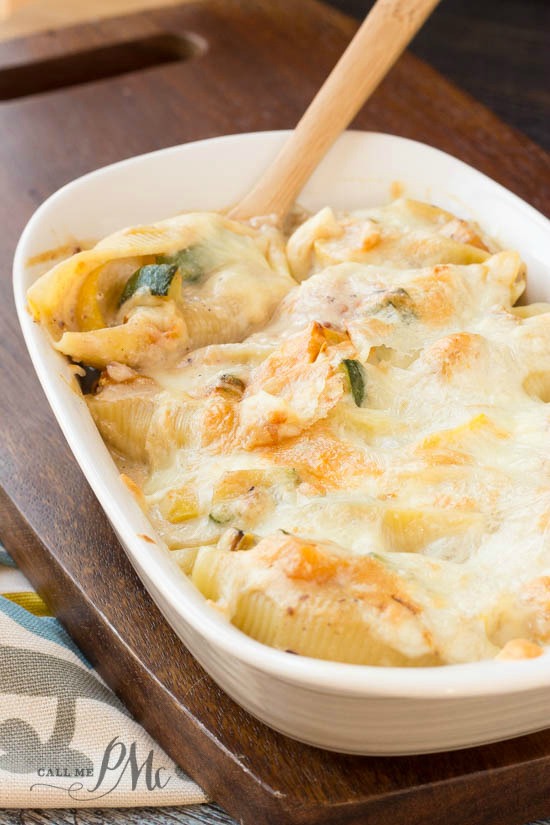 butternut squash stuffed shells in a white casserole dish.