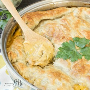 wooden spoon in a dish of puff pastry chicken pot pie.