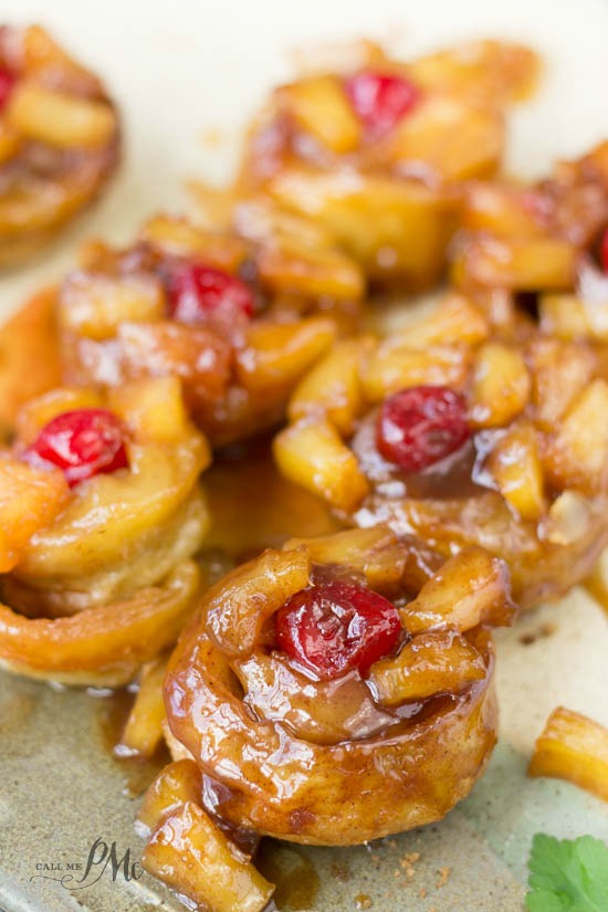 5 ingredient puff pastry pineapple upside down cinnamon rolls are ready from start to finish in less than 30 minutes. Seriously the best cinnamon rolls/ dessert I've ever eaten! #pineapple #pineappleupsidedown #dessert #breakfast #brunch #reicpe #easy A close-up of a caramel-glazed pastry topped with a red cherry and small pineapple.